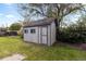 Charming backyard shed featuring a classic design with a door and two windows at 8305 Eaton Way, Arvada, CO 80003