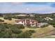 An aerial view of the back of the home with walkout deck and mountain views at sunset at 1701 Creedmoor Ct, Castle Rock, CO 80109