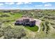 Aerial view shows a private home on a large lot with lush landscaping and covered deck at 1701 Creedmoor Ct, Castle Rock, CO 80109