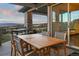 Outdoor deck dining area with seating for six and scenic views at 1701 Creedmoor Ct, Castle Rock, CO 80109