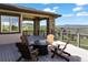 Inviting outdoor deck with stone columns, mountain views, and cozy seating arrangement at 1701 Creedmoor Ct, Castle Rock, CO 80109