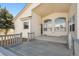 The back patio features a porch overlooking the yard. The house has light yellow siding and tan trim at 24783 E Arkansas Pl, Aurora, CO 80018