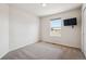 The bedroom features an empty room, neutral carpet and walls, and a window at 24783 E Arkansas Pl, Aurora, CO 80018