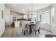 Bright dining area features a chandelier, a window with natural light and flows into the open-concept kitchen at 24783 E Arkansas Pl, Aurora, CO 80018
