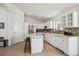 Spacious kitchen featuring white cabinets, stainless steel appliances, and a functional island at 24783 E Arkansas Pl, Aurora, CO 80018