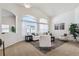 Bright and airy living room with large windows, vaulted ceilings, and neutral decor at 24783 E Arkansas Pl, Aurora, CO 80018