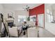 Bright living room with a fireplace, ceiling fan, and a large window with backyard views at 24783 E Arkansas Pl, Aurora, CO 80018