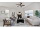 Comfortable living room with a cozy fireplace, neutral furniture, and bright natural light at 24783 E Arkansas Pl, Aurora, CO 80018