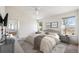 The main bedroom features a ceiling fan, two windows, and an ensuite bathroom with a tub and shower at 24783 E Arkansas Pl, Aurora, CO 80018