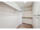 The empty walk-in closet features shelving racks, neutral walls, and carpeted floors at 24783 E Arkansas Pl, Aurora, CO 80018
