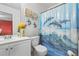 Inviting bathroom featuring a single sink vanity, dolphin-themed shower curtain, and stylish decor at 892 Macaw St, Brighton, CO 80601