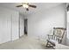 Cozy bedroom features a rocking chair and neutral carpet at 892 Macaw St, Brighton, CO 80601