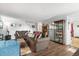 Inviting living room with hardwood floors, a display cabinet, and comfortable sofas, perfect for Gathering gatherings at 892 Macaw St, Brighton, CO 80601