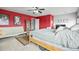 Bright main bedroom featuring a large bed, a futon, built-in bookshelves and a dedicated workspace at 892 Macaw St, Brighton, CO 80601