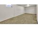 Unfinished basement featuring carpeting and a small window providing natural light at 1225 S Honey Way, Denver, CO 80224