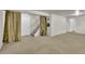 Finished basement featuring neutral carpeting and staircase with decorative curtains at 1225 S Honey Way, Denver, CO 80224