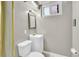 Bathroom featuring a toilet and sink with decorative mirror and lighting at 1225 S Honey Way, Denver, CO 80224