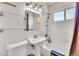 Bathroom with tiled walls, vanity sink, and shower-tub combination featuring chrome fixtures at 1225 S Honey Way, Denver, CO 80224