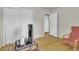Bedroom featuring hardwood floors, a double door closet and a view into an adjoining room at 1225 S Honey Way, Denver, CO 80224