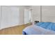 This bedroom has hardwood floors, an oversized closet and a view to the bathroom at 1225 S Honey Way, Denver, CO 80224