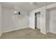 Finished bedroom features neutral carpeting, a window, and closet space at 1225 S Honey Way, Denver, CO 80224