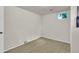 A simple carpeted bedroom with light walls and one window at 1225 S Honey Way, Denver, CO 80224