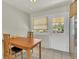 Bright breakfast nook features tile floor, a door to backyard, and a simple wooden dining table set at 1225 S Honey Way, Denver, CO 80224