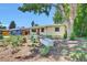 Charming single-story home featuring a drought friendly landscaped front yard with garden boxes at 1225 S Honey Way, Denver, CO 80224
