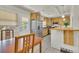 Light and airy kitchen features wood cabinets, stainless steel appliances, and door to backyard at 1225 S Honey Way, Denver, CO 80224