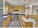 Well-lit kitchen with stainless steel appliances and wood cabinets that offer lots of storage at 1225 S Honey Way, Denver, CO 80224