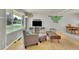 Bright living room with large picture window, light wood floors, and comfortable seating at 1225 S Honey Way, Denver, CO 80224