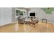 Inviting living room featuring a picture window and neutral decor and hardwood floors at 1225 S Honey Way, Denver, CO 80224