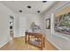 Bright home office featuring hardwood floors and natural light from a large window at 1225 S Honey Way, Denver, CO 80224