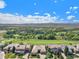 Aerial view of homes with mountain views and golf course at 9005 Stonecrest Way, Highlands Ranch, CO 80129