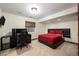 Basement bedroom with a red bed, desk and chair at 9005 Stonecrest Way, Highlands Ranch, CO 80129