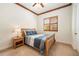 Bright bedroom with wood-framed bed, nightstand and window shutters at 9005 Stonecrest Way, Highlands Ranch, CO 80129