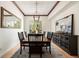 Elegant dining room with dark wood table and built-in buffet at 9005 Stonecrest Way, Highlands Ranch, CO 80129