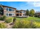 Luxury home with stone exterior and landscaped yard at 9005 Stonecrest Way, Highlands Ranch, CO 80129