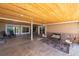 Covered patio with seating area and stamped concrete floor at 9005 Stonecrest Way, Highlands Ranch, CO 80129