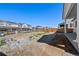 An expansive backyard featuring a view of neighboring houses at 9175 Uravan Ct, Commerce City, CO 80022