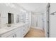 Bright bathroom featuring double sinks, neutral cabinets and an enclosed glass shower at 9175 Uravan Ct, Commerce City, CO 80022