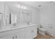 Bright bathroom with double sinks, large mirror, and modern fixtures at 9175 Uravan Ct, Commerce City, CO 80022