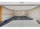 Spacious two car garage with shelving and a door leading to the interior of the home at 9175 Uravan Ct, Commerce City, CO 80022