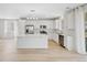 Stylish kitchen with white cabinetry, stainless steel appliances, and a large center island at 9175 Uravan Ct, Commerce City, CO 80022