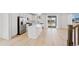 Contemporary kitchen boasts an island, stainless steel appliances, and hardwood floors at 9175 Uravan Ct, Commerce City, CO 80022