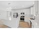 Modern kitchen with white cabinetry, stainless steel appliances, and a center island with a quartz countertop at 9175 Uravan Ct, Commerce City, CO 80022