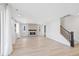 Spacious living room with a modern fireplace and hardwood floors at 9175 Uravan Ct, Commerce City, CO 80022