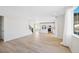 Bright living room features wood floors, staircase, and an open concept layout at 9175 Uravan Ct, Commerce City, CO 80022