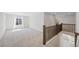 Spacious loft area with neutral carpet and a window for natural light at 9175 Uravan Ct, Commerce City, CO 80022