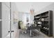 A furnished home office features light wood floors, a desk, and built-in bookshelves at 9175 Uravan Ct, Commerce City, CO 80022